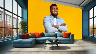 Confident african american guy standing with his arms crossed Wall mural