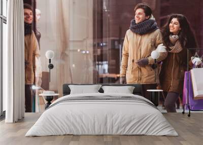 Couple Doing Winter Shopping Carrying Shopper Bags In Night City Wall mural