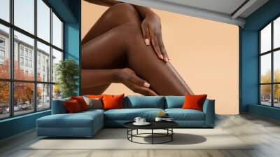 Cropped of black lady touching her silky legs Wall mural