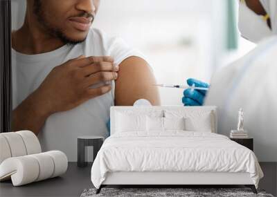 Cropped of black man receiving vaccine shot Wall mural