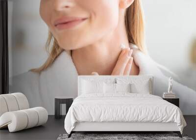 Cropped of lady pampering neck skin with moisturizer in bathroom Wall mural