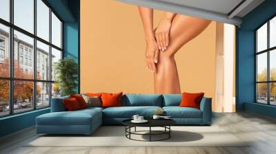 Cropped of young slim woman touching her smooth legs, hair removing cosmetics, laser hair removal, waxing concept Wall mural