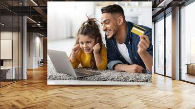 Dad And Little Daughter With Laptop And Credit Card Making Online Shopping Wall mural