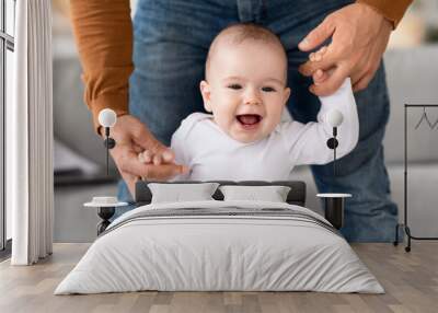 Daddy Helping His Baby Walk, Make First Steps At Home Wall mural