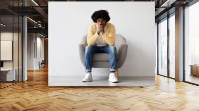 Depression Concept. Portrait Of Sad Pensive Black Guy Sitting In Armchair At Home Wall mural