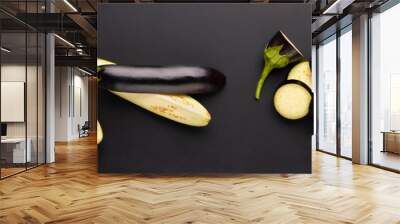 Different pieces of eggplant isolated on black background Wall mural