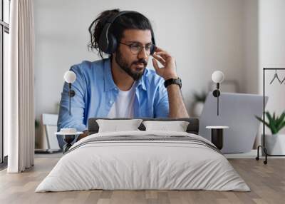 Distance Learning. Western Man In Headphones Studying Online With Laptop At Home Wall mural