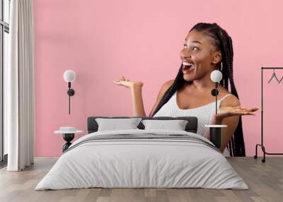 Emotional black lady in summer dress looking at empty space in surprise, screaming OMG on pink studio background Wall mural