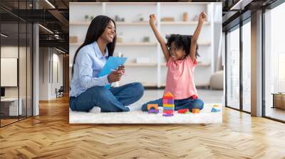 Emotional little girl raising hands up, having session with psychologist Wall mural