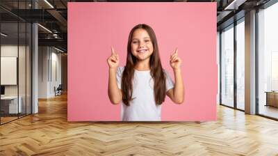 Emotions of happy preschooler. Funny little kid shows two fingers up at copy space Wall mural