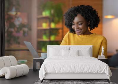 Enthusiastic student girl looking for job online, using laptop Wall mural