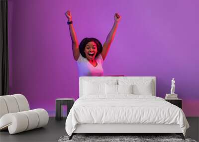 Euphoric Black Female With Laptop Celebrating Success In Neon Light Wall mural