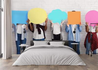 Everyone has own opinion. Teens holding empty speech bubbles Wall mural