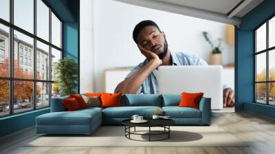 Exhausted African American worker felt asleep at workplace Wall mural