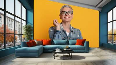 Eyewear Fashion. Happy Middle-Aged Woman Posing In Stylish Eyeglasses Over Yellow Background Wall mural