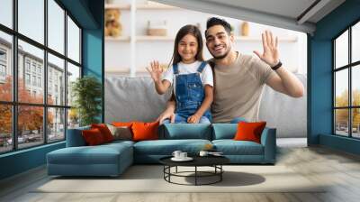 Family laptop waving hands and posing at camera Wall mural