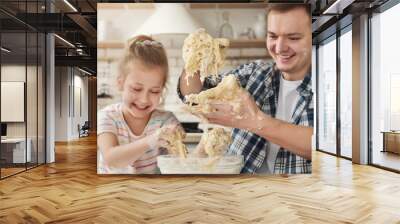 Father is cooking pastry with daughter Wall mural