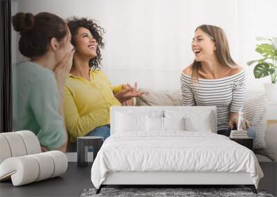 Female friends talking, gossiping in the living room at home Wall mural