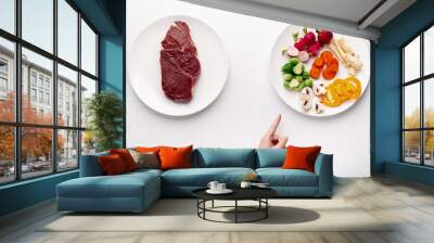 Female hand pointing at plate with organic vegetables Wall mural