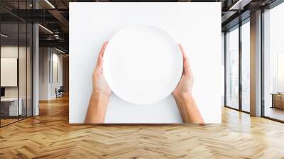 female hands holding empty plate on white background Wall mural