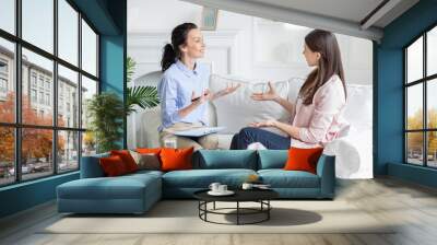 Female patient and psychotherapist having positive inspiring conversation Wall mural