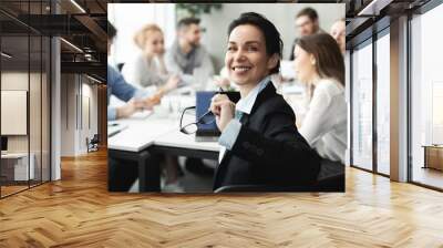 Female top manager smiling to camera at meeting Wall mural