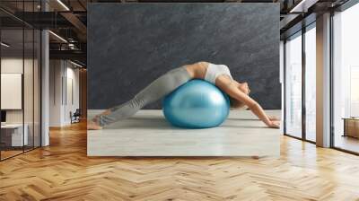 Fitness woman training with fitness ball indoors Wall mural