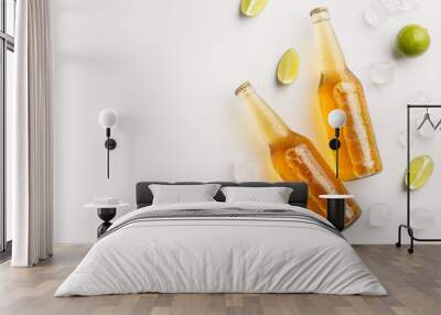 Freshen up and drink at summer. Bottles with beer in ice and pieces of lime on white background Wall mural