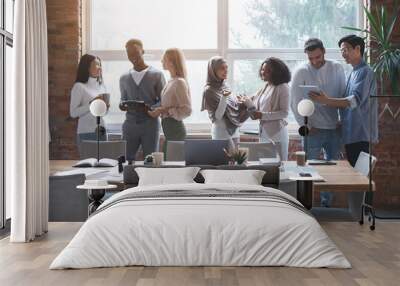 Friendly business team talking while having break Wall mural