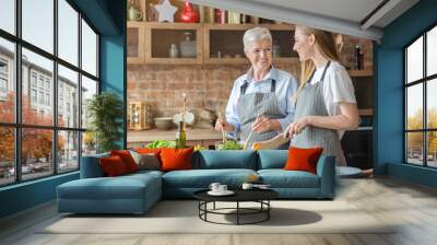 Friendly mother and daughter making healthy dinner together Wall mural