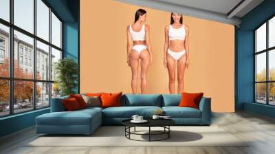 Full length shot of front and back view of slim lady posing on beige background, demonstrating perfect body shape Wall mural