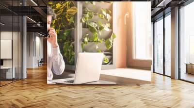 Great news. Happy businessman having smartphone conversation, working in cafe with clients, empty space Wall mural