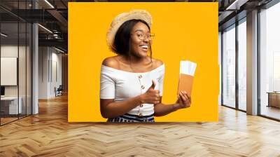 Great Vacation. Smiling Black Woman Holding Tickets And Passport Gesturing Thumbs Up Standing Over Orange Background. Studio Shot, Panorama Wall mural