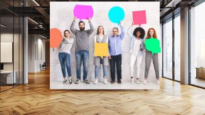 Group of diverse friends holding blank colorful speech bubbles Wall mural