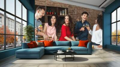 Group of friends having small home party Wall mural