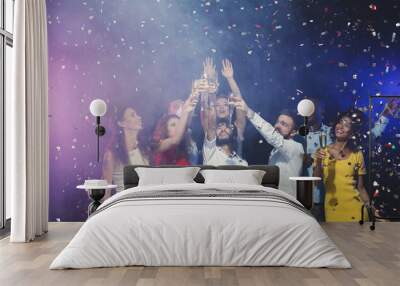 Group of young people celebrating new year with champagne at night club Wall mural