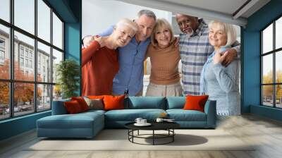 Group photo of happy elderly people hugging, smiling at camera Wall mural