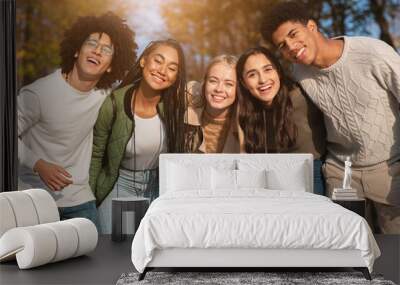 Group portrait of happy multiracial teenaged friends outdoors Wall mural