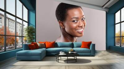 Half-turned beautiful black woman with white smile and clean skin Wall mural