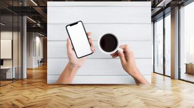 Hand using smartphone on white wooden background Wall mural