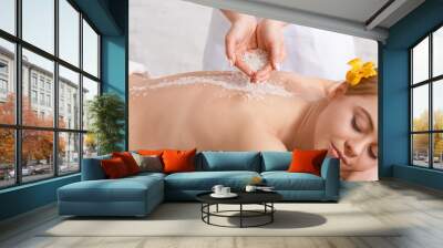 Hands of professional doing massage with salt for woman with closed eyes on table Wall mural