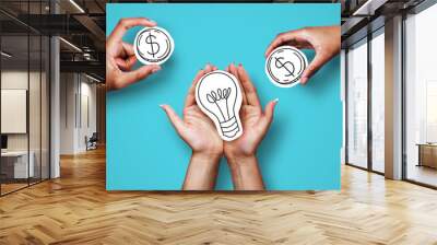 Hands with dollar sign coins and light bulb Wall mural