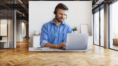 Handsome Young Man In Headset Study Online, Watching Webinar On Laptop Wall mural