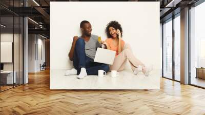 Happy african-american couple shopping online Wall mural