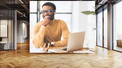 Happy black businessman listening to music at home Wall mural