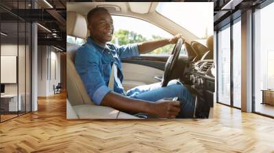 Happy black guy driving car, going to job Wall mural