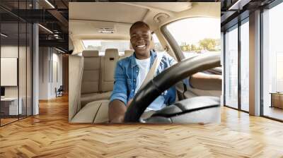 Happy black guy driving his new car, going to job Wall mural