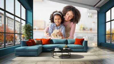 Happy black woman and girl preparing dough in kitchen Wall mural