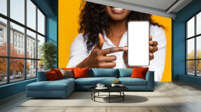 Happy black woman holding latest slim smartphone Wall mural