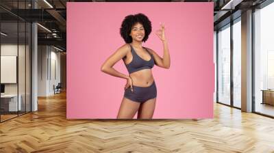 happy black woman in underwear attire showing ok sign Wall mural